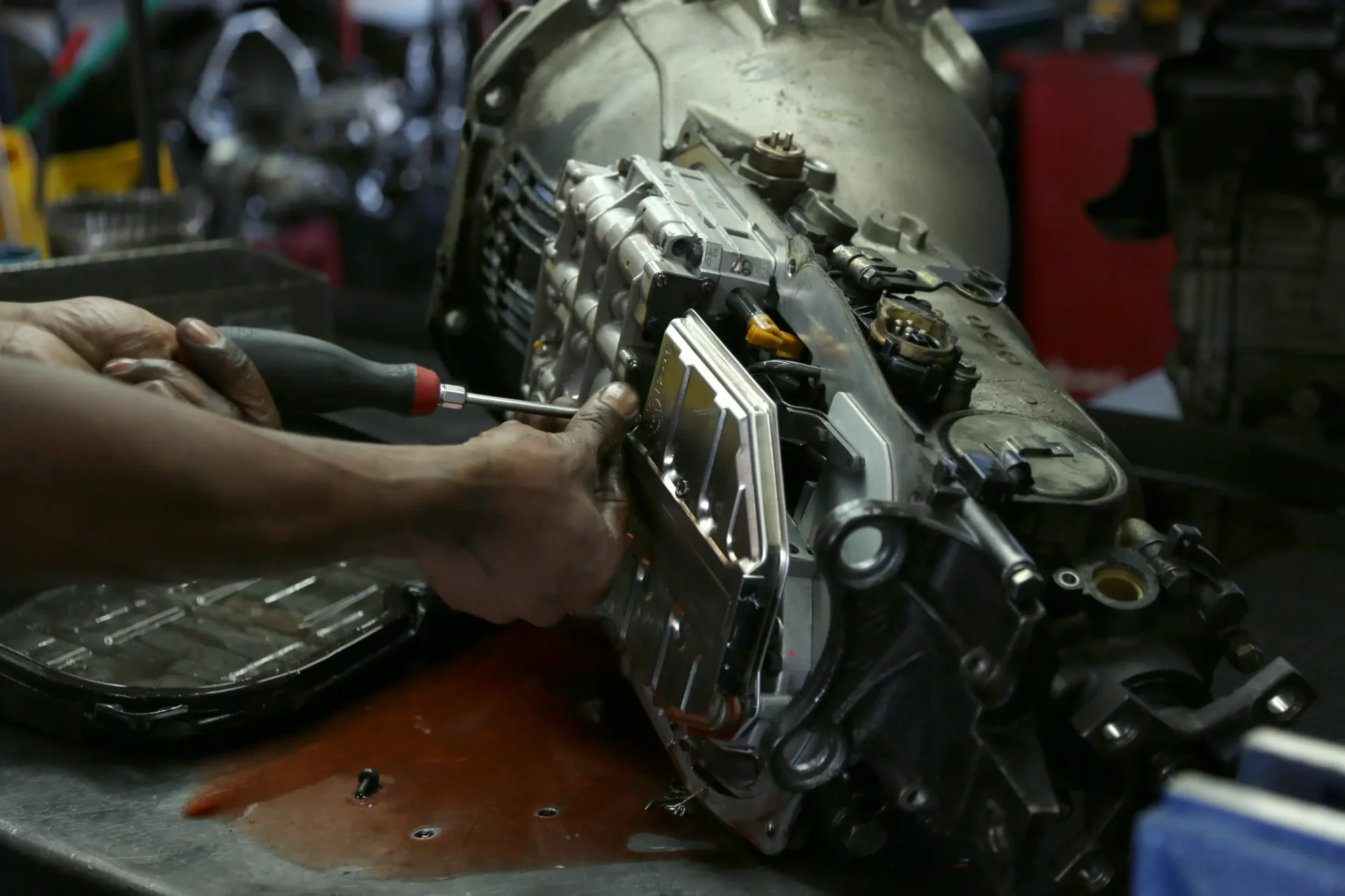 Mechanic repairing an automatic transmission.